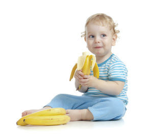 Счастливые ребенок с бананом